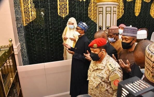 •*President Muhammadu Buhari and others offering prayers at the mosque in Madinah
(Photo: Garba Shehu, Facebook)