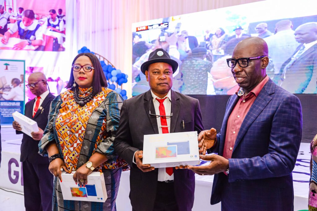 Edo State Commissioner for Education, Dr. Joan Osa Oviawe; Principal, Ebhoiyi Senior Secondary School, Uromi, Elder Ojiezele Dennis, and Edo State Governor, Mr. Godwin Obaseki, during the governor’s presentation of electronic devices to school principals in Edo State, at the New Era College, in Benin City.