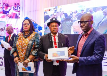 Edo State Commissioner for Education, Dr. Joan Osa Oviawe; Principal, Ebhoiyi Senior Secondary School, Uromi, Elder Ojiezele Dennis, and Edo State Governor, Mr. Godwin Obaseki, during the governor’s presentation of electronic devices to school principals in Edo State, at the New Era College, in Benin City.