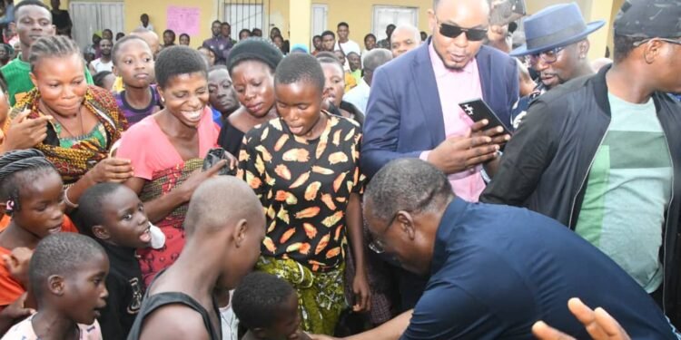 •Delta Governor and Vice-Presidential Candidate of the PDP, Senator (Dr) Ifeanyi Okowa, playing with one of the  children at an Internally Displaced Persons (IDPs) camp for flood victims at Alaka Grammar School, Ozoro, Isoko North LGA, during his visit to the camp on Wednesday.  Photo: BRIPIN ENARUSAI