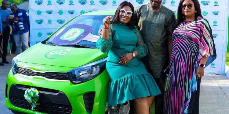 •Mrs. Adeife Abiodun-Adeyemi...winner of Kia car prize showing off the keys of the car