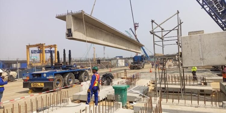 *Beam being transferred from a vehicle to the bridge.
PHOTO: Julius Berger