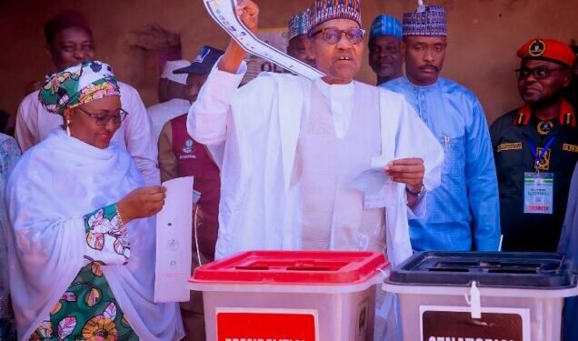 *FILE: President Muhammadu Buhari displaying his ballot paper after thumb-printing