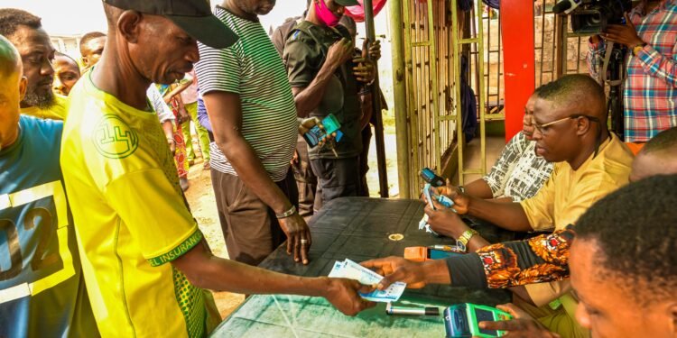 *Residents withdrawing new naira notes during monitoring of the disbursement of cash to Point of Sales (POS) operators and residents by officials of the Central Bank of Nigeria in Benin City, on Thursday, February 16, 2023.