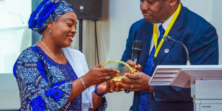 *Dr. Victoria Ogala-Akogwu (l) receiving a plaque from Dr Uvie Onakpoya (r)