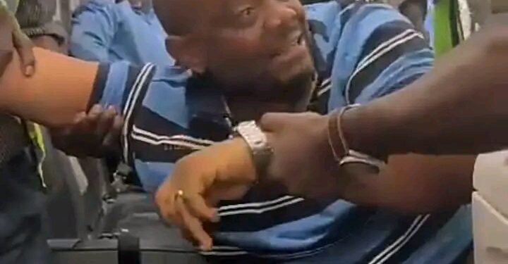 *The unruly passenger being forcefully disembarked from the aircraft