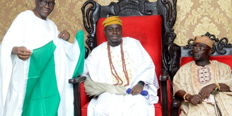 NOA DG, Mr Garba Abari presenting Nigeria flag to the Olu of Ikeja Land, Regent Isiaka Apena on Wednesday in Lagos