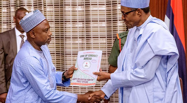 *President Muhammadu Buhari (r) receiving the Assets declaration form from Prof. Isah Mohammed, the chairman of the Code of Conduct Bureau (l)