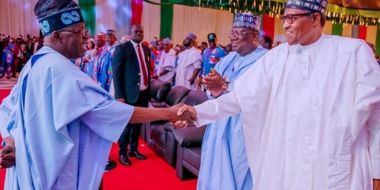 *President Muhammadu Buhari in a warm handshake with Bola Tinubu