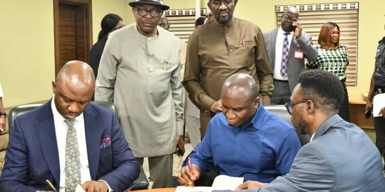 *The Lead Partner and Head, Governance Processes, KPMG, Mr. Tolu Odukale (left) and the NDDC Managing Director, Dr. Samuel Ogbuku, signing agreement at the NDDC headquarters in Port Harcourt. Behind them are NDDC Executive Director Finance and Administration, Major General Charles Airhiavbere (Rtd) and Executive Director, Projects, Mr. Charles Ogunmola.