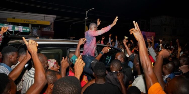 Philip Shaibu acknowledging cheers from the mammoth crowd as he arrives Jattu, Edo State on Thursday night.