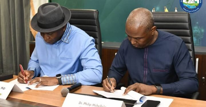 *Managing Director and Chief Executive Officer, Dr. Philip Mshelbila (r), and the NDDC's luminary Managing Director, Dr. Samuel Ogbuku (l) during the signing ceremony.