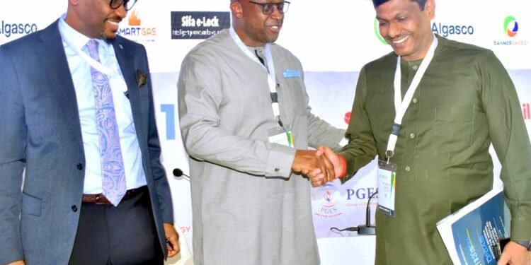 **President Nigeria Liquefied Petroleum Gas Association ( NLPGA ) ,Felix Ekundayo (M) shakes MD ,NIPCO Plc ,Suresh Kumar during the Association 13th Conference in Abuja while MD, Banner Energy, Nuhu Yakubu watches