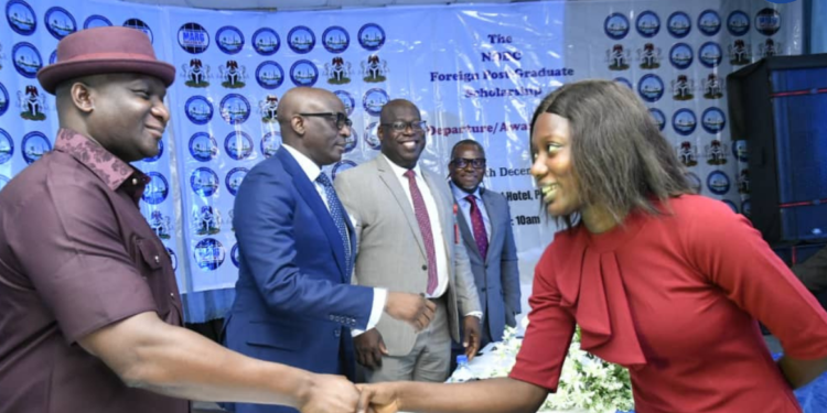 *The NDDC Managing Director, Dr Samuel Ogbuku, (left) congratulating the best performing scholarship student, Miss Omogbemi Olayemi, during a pre-departure and award ceremony for the Foreign Post Graduate Scholarship in Port Harcourt. Second left is Chairman of the NDDC Governing Board, Mr. Chiedu Ebie, followed by the Director, Education, Health and Social Services, Dr George Uzonwanne.