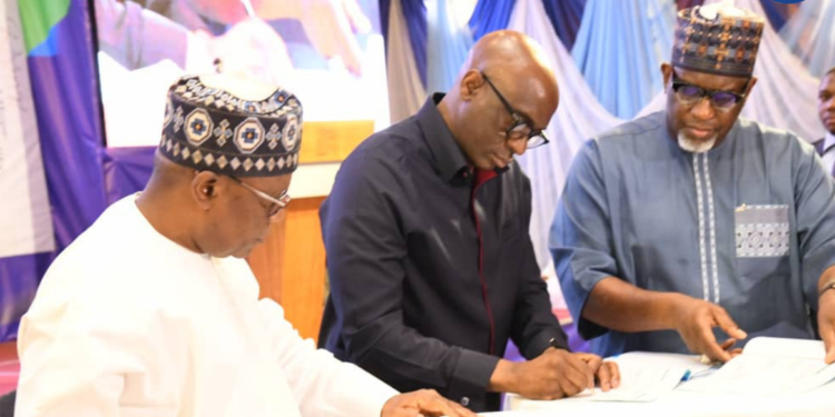 *From left to right: the Minister of Niger Delta Development, Engr. Abubakar Momoh; the Chairman NDDC Board, Mr. Chiedu Ebie, signing the Performance Bond at the center; and the Permanent Secretary, Dr. Shuaib Belgore, are pictured during the Two-Day Board and Management Retreat of the Niger Delta Development Commission, held at Four Points by Sheraton, Ikot Ekpene, Akwa Ibom State.