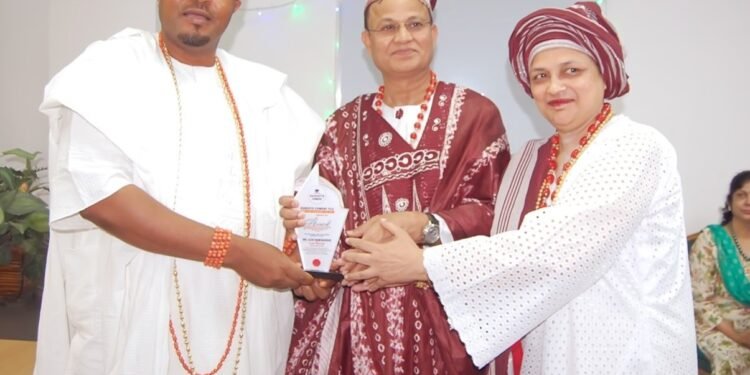*Outgoing Dangote Cement, Ibese Plant Director, Azad Nawabuddin (middle) receiving an award from the Aboro of Ibeseland, Oba Rotimi Mulero (left) and his wife, Romana, during the sent forth ceremony by the Ibese Plant management.
