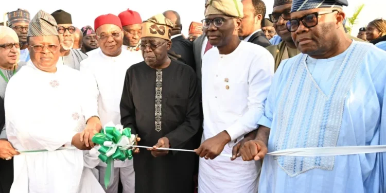 *President Bola Tinubu () cutting the tape to officially Flag-off the construction of Lagos-Calabar Coastal Highway in Lagos on Sunday (26/5/2024). With him are from left: Minister of Works, Sen Dave Umahi; Gov Hope Uzodimma of Imo State; Gov Babajide Sanwo-Olu of Lagos State and the President of the Senate, Godswill Akpabio