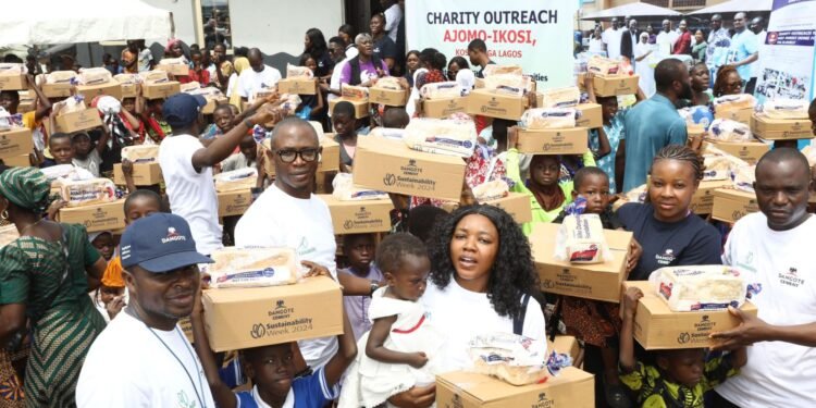 Beneficiaries with their food items distributed by Dangote Cement Volunteers during the Sustainability Week celebrations in Lagos.