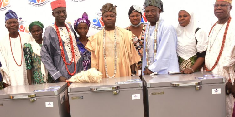 DSC7266: L-R: Somofe of Ibese Land, Chief Tajudeen Adewuyi; Duropitan Adepeju, beneficiary; Awujako of Ijako Orile, Oba Mathew Alabi Ewedairo; Wosilatu Ojuoro, beneficiary; Aboro of Iboro, Oba Daniel Abayomi Salako; Adenike Obadina, beneficiary; Olu of Aga Olowo, Oba Kayode Adio Kusoro; Morufat Akanni, beneficiary; Olu of Onigbedu, Oba Mathew Ayinde Ajibulu, during the presentation of deep freezes to the beneficiaries,  at the Dangote Cement Ibese Plant  2024 Community Day at the Dangote Cement Estate, Ibese, Ogun State on Wednesday, December 11, 2024