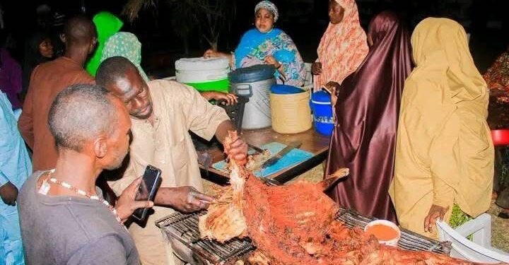 Hajia Rabius Salisu dishing out the iftar meal to Muslim faithful
