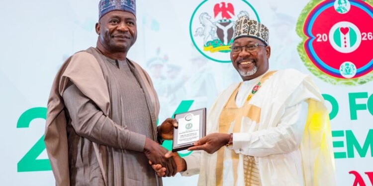 *Minister of Defence, Gen Chris Musa (l) handing in a plaque to former spokesman of the Nigerian Army, Brig-Gen SK Usman (r)...at the State House , Abuja.