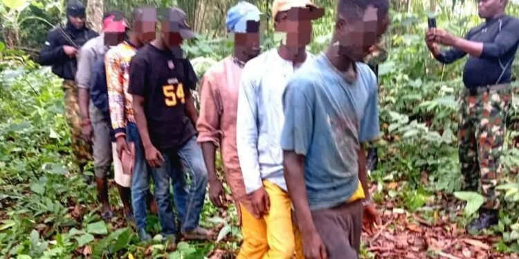 The suspects being lined out by troops