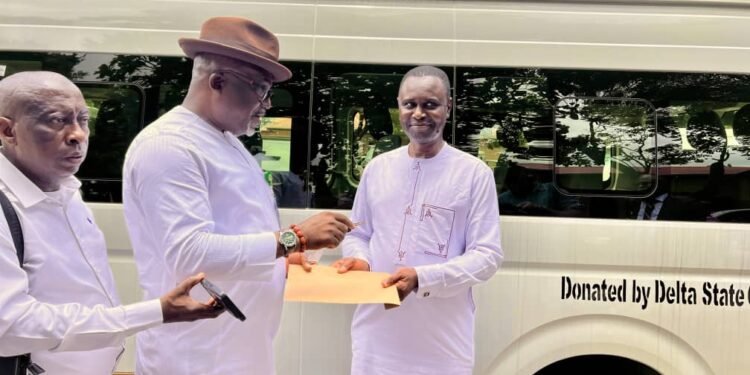 Chief Press Secretary to the Governor of Delta State, Sir Festus Ahon (left), presents the keys to a brand-new 18-seater Toyota Hiace bus donated by the Delta State Government to the Chairman, Nigeria Union of Journalists (NUJ), Delta State Council, Comrade Churchill Oyowe (right), at Government House, Asaba, on Tuesday. PHOTO: SAMUEL JIBUNOR