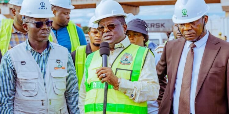 Minister of Works, Engr. David Umahi (middle), briefing journalists shortly after ordering the arrest of the Managing Director of Hartland Nigeria Limited over the alleged abandonment of the Asaba-Onitsha Road project, during the Minister’s inspection visit to the Asaba-Onitsha section of the road on Thursday, as the Commissioner for Works (Rural Roads) and Public Information, Delta State, Mr. Charles Aniagwu (right), and Director Highways, Bridges and Designs Federal Ministry of Works, Engr. Saidu Musa (left) look on. PHOTO: SAMUEL JIBUNOR